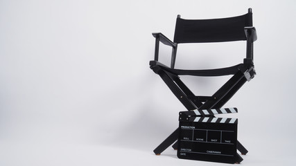 Black Clapper board or movie slate with director chair use in video production or movie and cinema industry. It's put on white background.