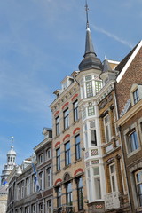 Colorful architecture of house facades on Grote Gracht street, with the City Hall (Stadhuis) on the left, Limbourg, Maastricht, Netherlands 