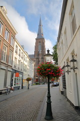 Fototapeta na wymiar Rechtstraat street, located in Wyck neighborhood, with Sint Martinuskerk church, Limbourg, Maastricht, Netherlands