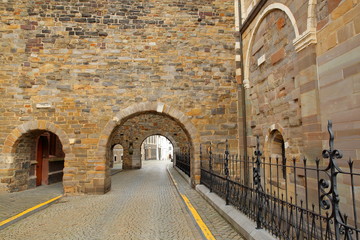 Fototapeta na wymiar Arches located on Sint Servaasklooster Street (Western side of the basilica of Saint Servatius, 11th century Cathedral), Vrijthof Square, Limbourg, Maastricht, Netherlands