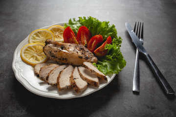 Grilled chicken on a white plate.