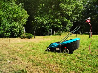 Obraz na płótnie Canvas lawn mower on green grass