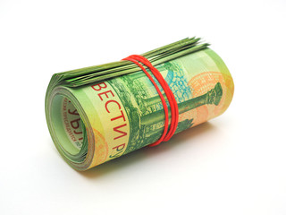 A bundle of Russian banknotes rolled into a roll of two hundred rubles. Banknotes are pulled together with an elastic band and lie on a white background. Close-up