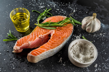 Raw organic fish salmon trout steak, with spices. Cooking food background.