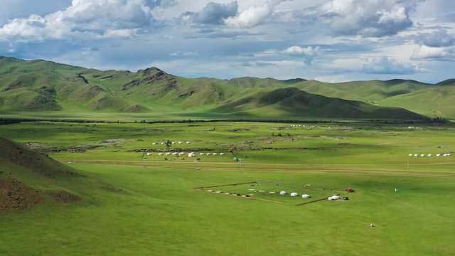 Aerial view of yurts in steppe and mountains landscape in Orkhon valley, Mongolia, 4k