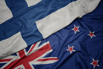 Fototapeta premium waving colorful flag of new zealand and national flag of finland.