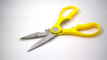 big yellow scissors on white background