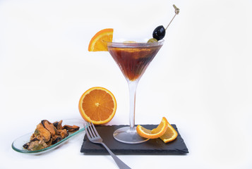 Delicious mussels in marinade, orange in slices accompanied by a delicious cocktail with olives - Isolated in a white background