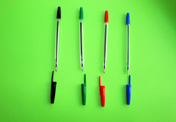 Colorful items for school, office on a green background.