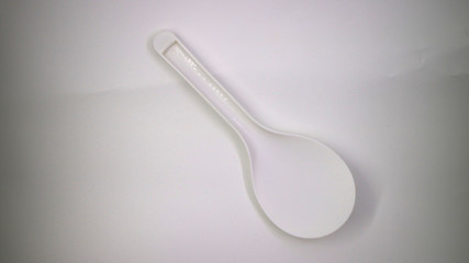 White plastic rice scoop spoon on white background