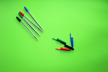 Colorful items for school, office on a green background.