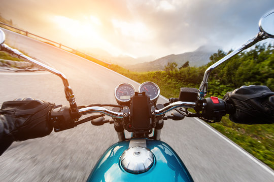 Motorcycle driver riding in mountains
