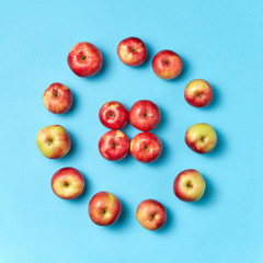 Round apples frame on a blue background.