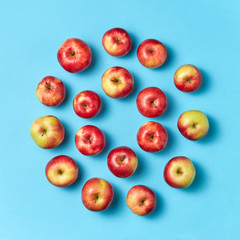 Organic apples round pattern on a blue background.
