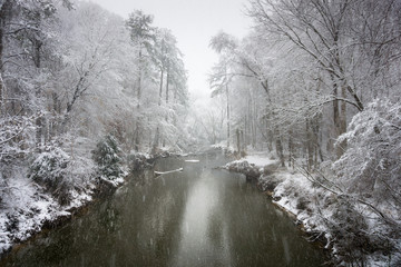 view from bridge over crabtree creek north carolina during a bitter winter snow squall, january 2018