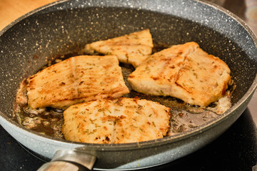 Cooking luce fillet on frying pan