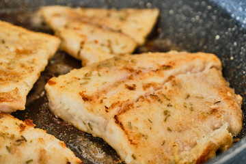 Cooking luce fillet on frying pan