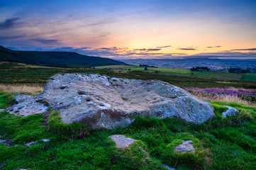 Sunset above Lordenshaws Hillfort Rock Art, located near Rothbury in Northumberland National Park and has several large stones with prehistoric rock art also known as Cup and Ring Marks