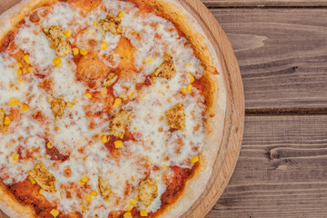 Hawaiian pizza on dark rustic wooden background. Top view, copy space