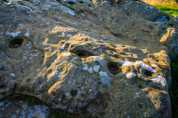 Close-up of Lordenshaws Hillfort Rock Art, located near Rothbury in Northumberland National Park and has several large stones with prehistoric rock art