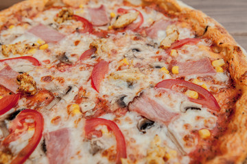 Pepperoni Pizza with Mozzarella cheese, Ham, Tomatoes, pepper, Spices . Italian pizza.