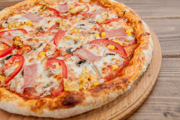 Pepperoni Pizza with Mozzarella cheese, Ham, Tomatoes, pepper, Spices . Italian pizza.