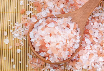 Himalayan rock salt with wooden spoon on bamboo background