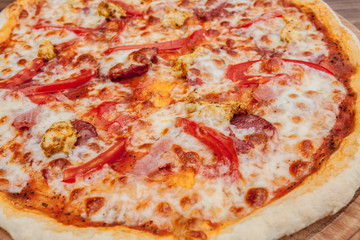 Pizza with Mozzarella cheese, salami, Tomatoes, pepper, Spices. Italian pizza