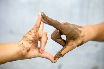 Concept of equality, respect, employment, deal, business with the symbol of handshake b/w a farmer with a hand having mud and a businessman's hand.