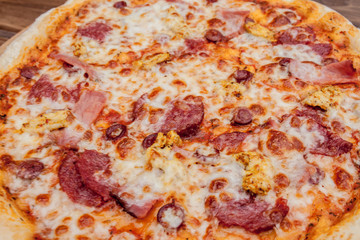 Pizza with Mozzarella cheese, salami, Tomatoes, pepper, Spices. Italian pizza
