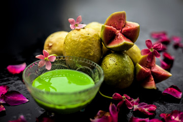 Fototapeta na wymiar Guava, Neem or Indian lilac leaves, turmeric powder well mixed in a glass bowl for treatment of pimples and acne in the spa by beauticians.