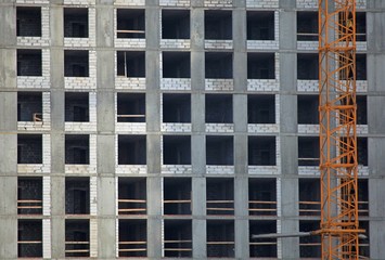 Monolithic construction of a multi-storey apartment building. Construction site. Construction in progress and concrete house frame