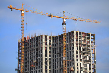 Fototapeta na wymiar Building construction site with cranes. High-rise buildings and construction cranes. Buildings under construction