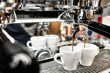 Coffee machine making two cups of espresso close-up