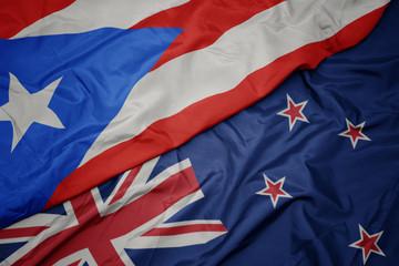 waving colorful flag of new zealand and national flag of puerto rico.