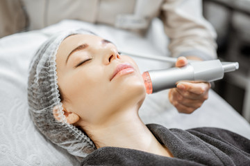 Woman during the oxygen mesotherapy procedure at the beauty salon, close-up view. Concept of a...