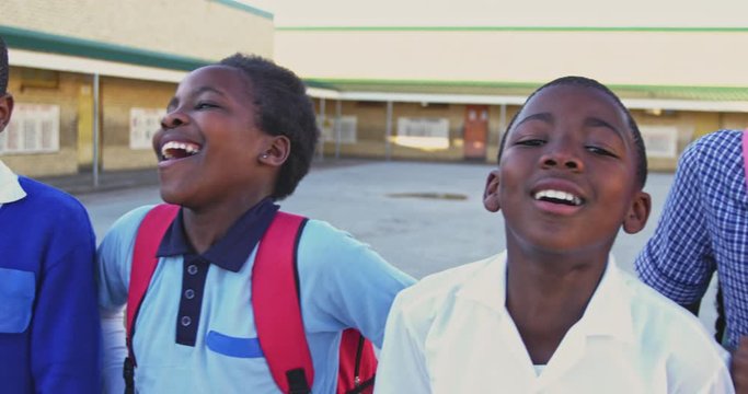 Young African American schoolchildren smiling in playground 4k