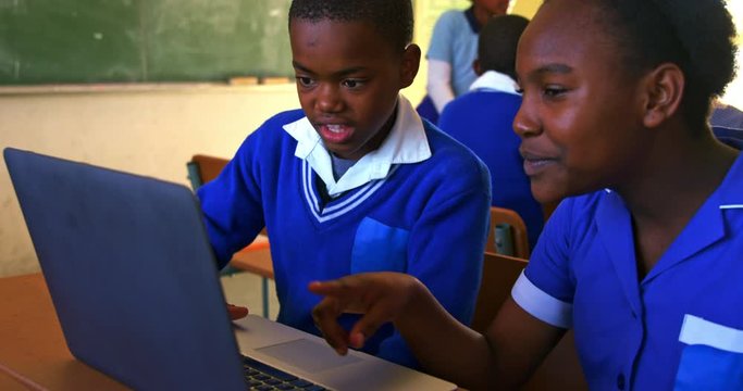 Schoolchildren using laptop in a lesson at a township school 4k