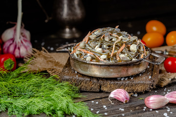 seaweed and carrot salad, mayonnaise sauce, in a rustic rustic bowl bowl, fork knife spoon, spices,...