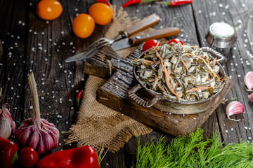 seaweed and carrot salad, mayonnaise sauce, in a rustic rustic bowl bowl, fork knife spoon, spices,...