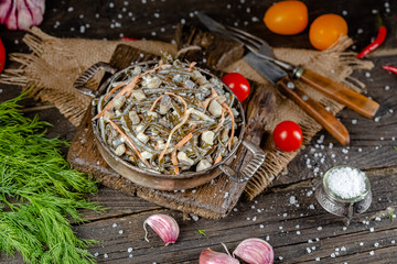 seaweed and carrot salad, mayonnaise sauce, in a rustic rustic bowl bowl, fork knife spoon, spices,...