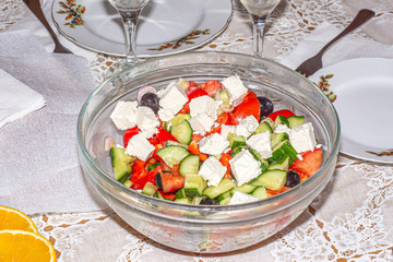 Greek salad in a glass bowl on the holiday table