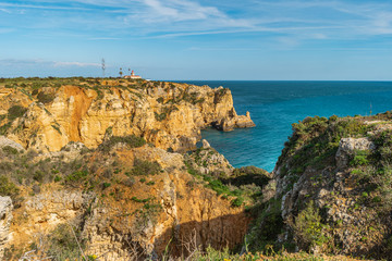 Fototapeta na wymiar View to lighthouse on Ponta da Piedade in Lagos, Algarve, Portugal.