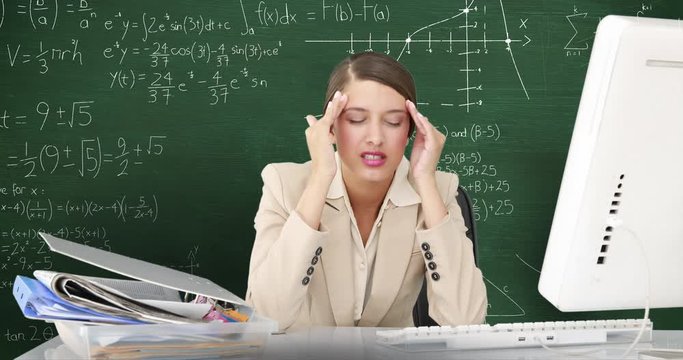 Woman in front of moving maths on blackboard