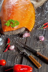 a large piece of red fish fillet with vegetables and spices and fresh herbs, stand and lie, from...