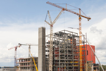 Cranes and building a modern factory building steel structure