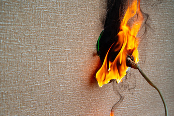Burning electrical wiring and electrical outlet. Faulty wiring causes fires. Poor old wiring causes...