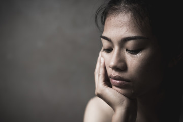 Woman sitting and crying. The concept of stopping violence against women andand human trafficking,  Stop sexual harassment and  rape, International Women's Day