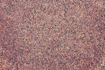 The background of polished granite in brown black shades. A background for design and creative work. Decoration and exterior decoration of the building. Construction works