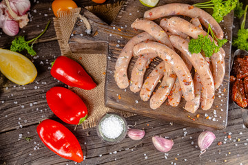 homemade hotdog sausages, raw from red and white fish meat, in a vintage rustic bowl plate, fork...